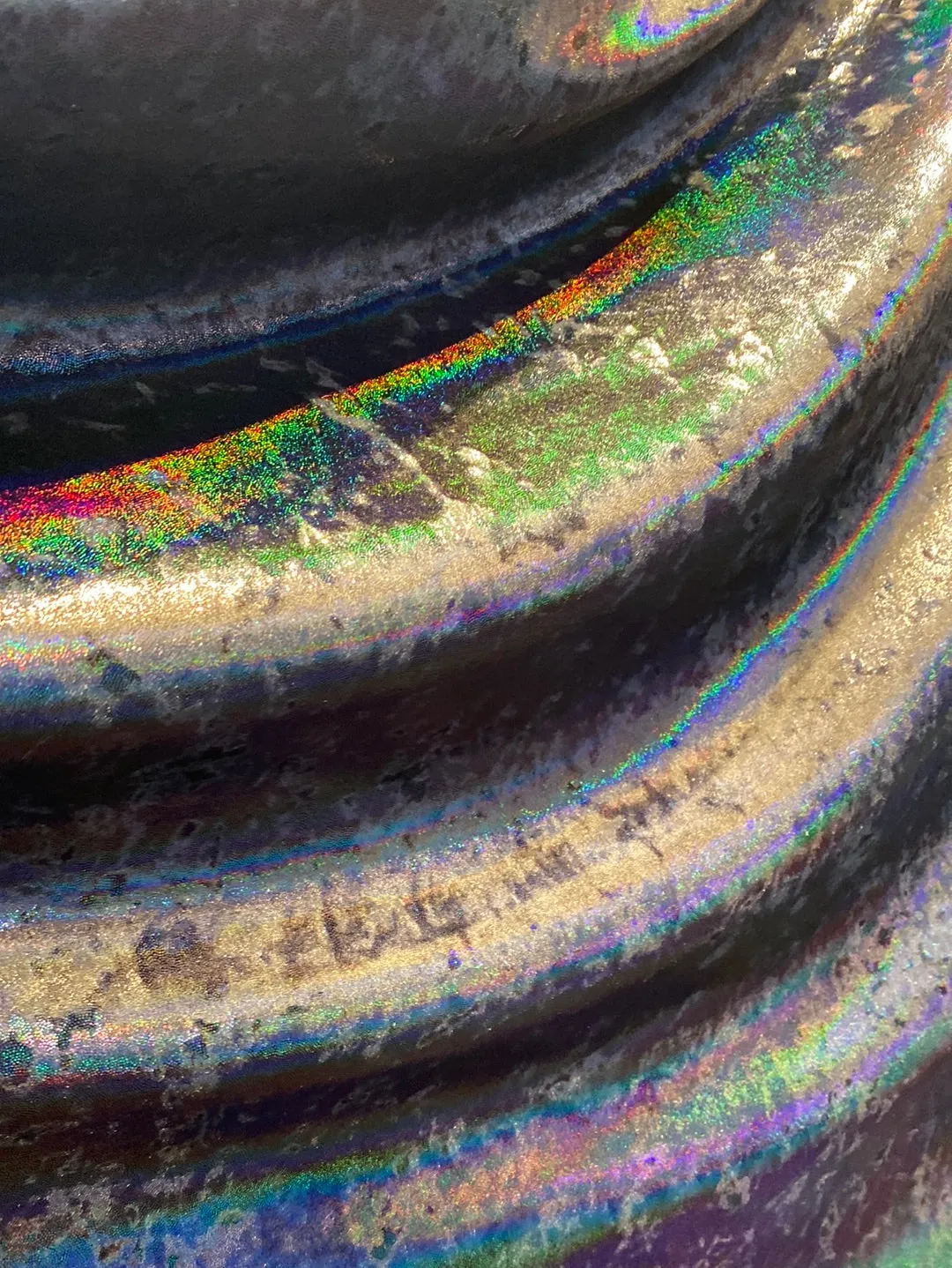 Velvet fabric with black iridescent, shiny mirror designs, stretches to all 4 sides sold by the yard