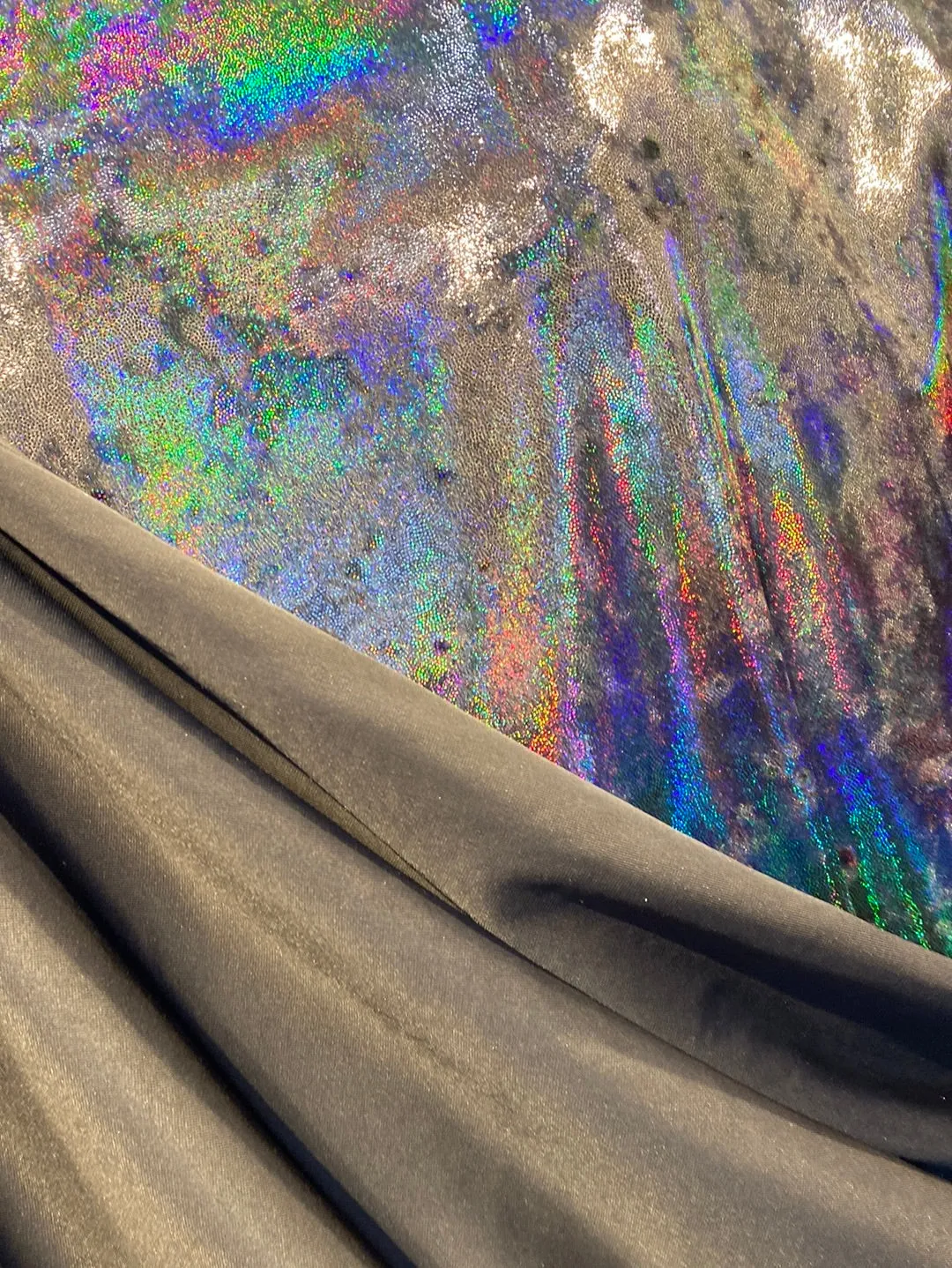 Velvet fabric with black iridescent, shiny mirror designs, stretches to all 4 sides sold by the yard